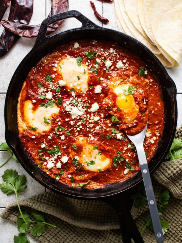 Huevos ahogados in a cast iron skillet.