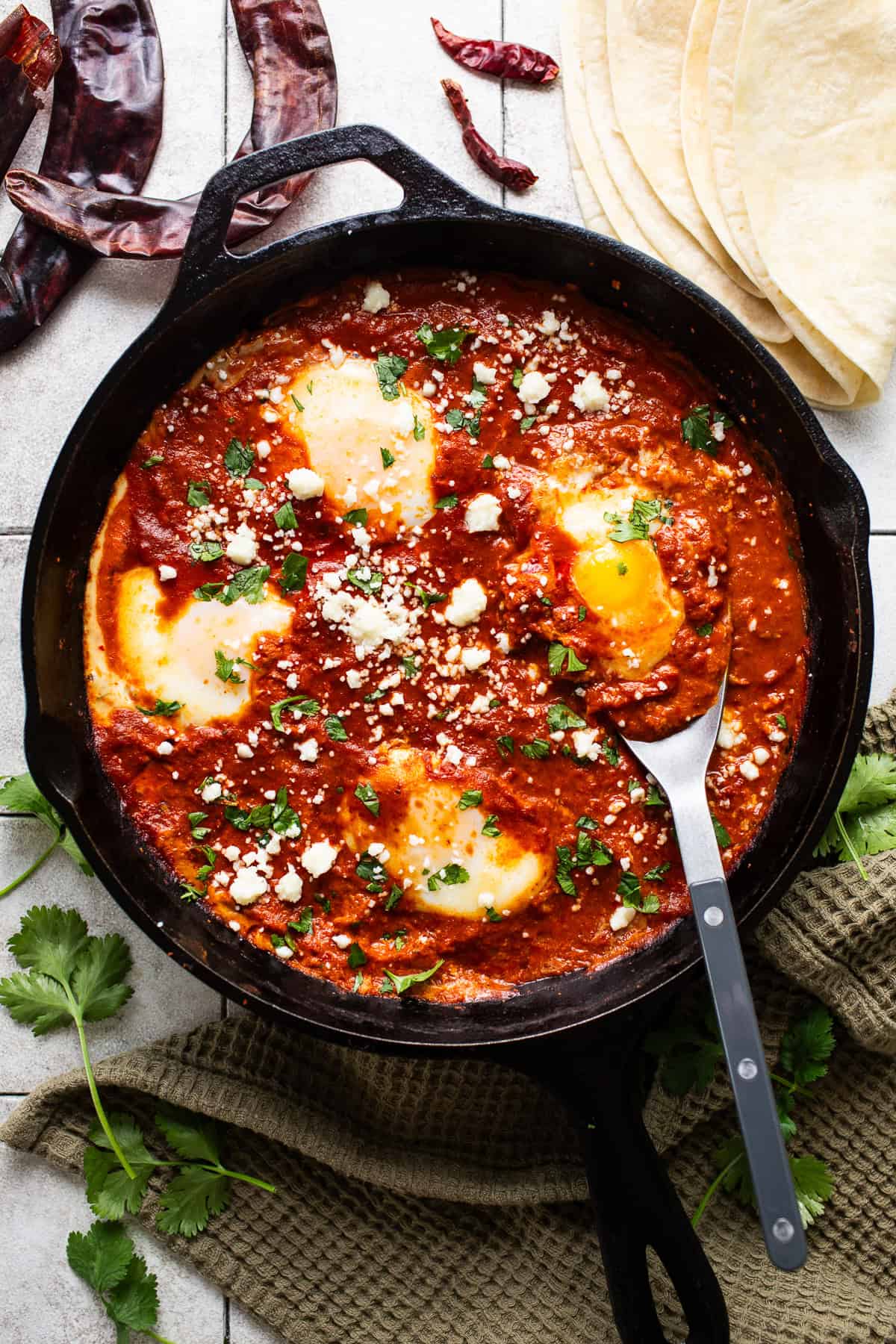 Huevos ahogados in a cast iron skillet.