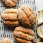 Telera bread rolls on a wire rack cooled and ready to eat.