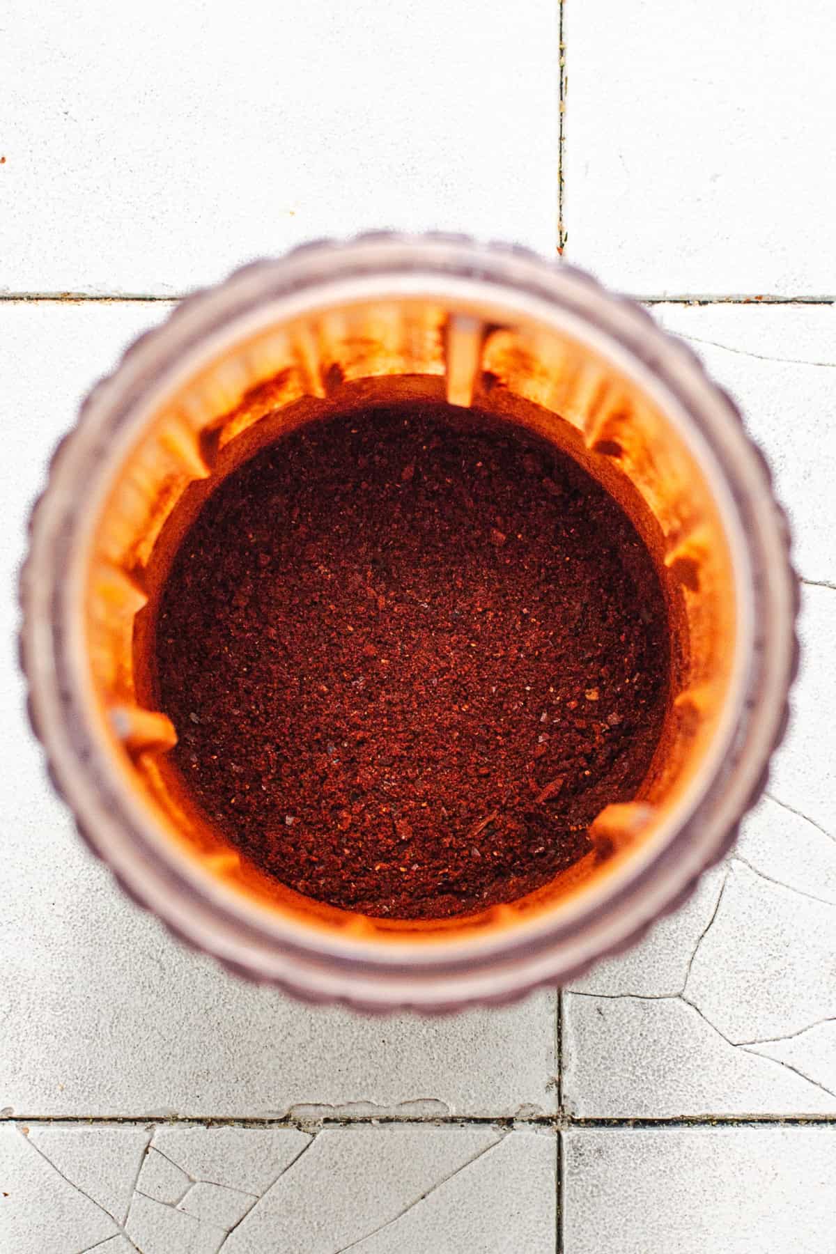 Guajillo chiles ground into a powder in a small blender.