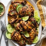 A serving plate filled with grilled chicken that has been marinated in a quick and easy Mexican chicken marinade.