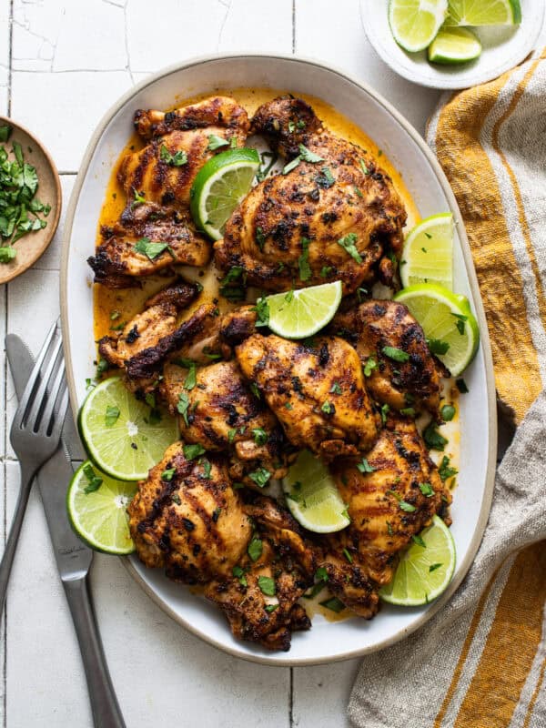 A serving plate filled with grilled chicken that has been marinated in a quick and easy Mexican chicken marinade.