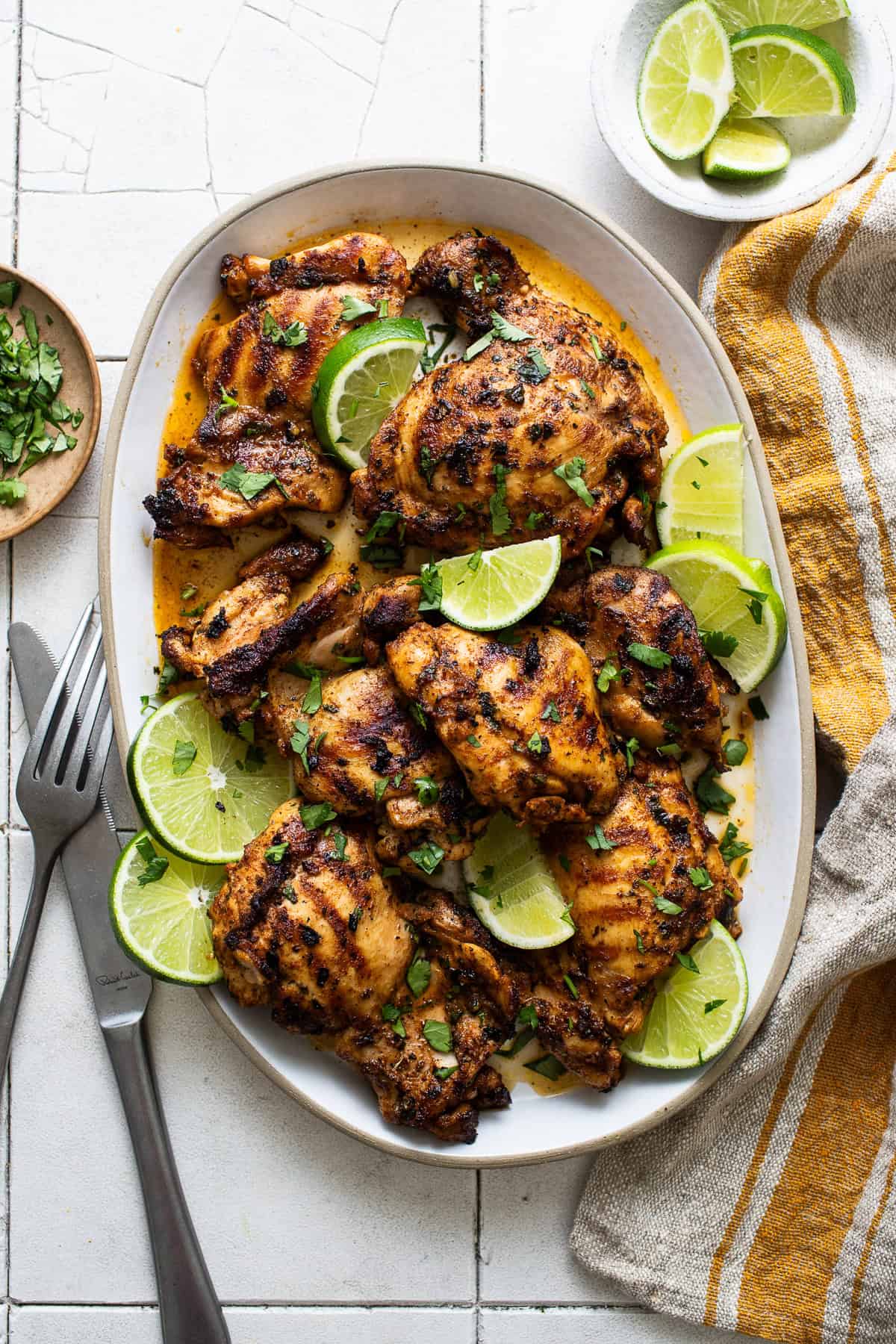 A serving plate filled with grilled chicken that has been marinated in a quick and easy Mexican chicken marinade.