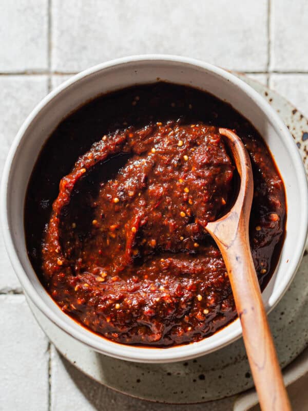 A bowl of salsa morita woth a wooden spoon ready to eat.