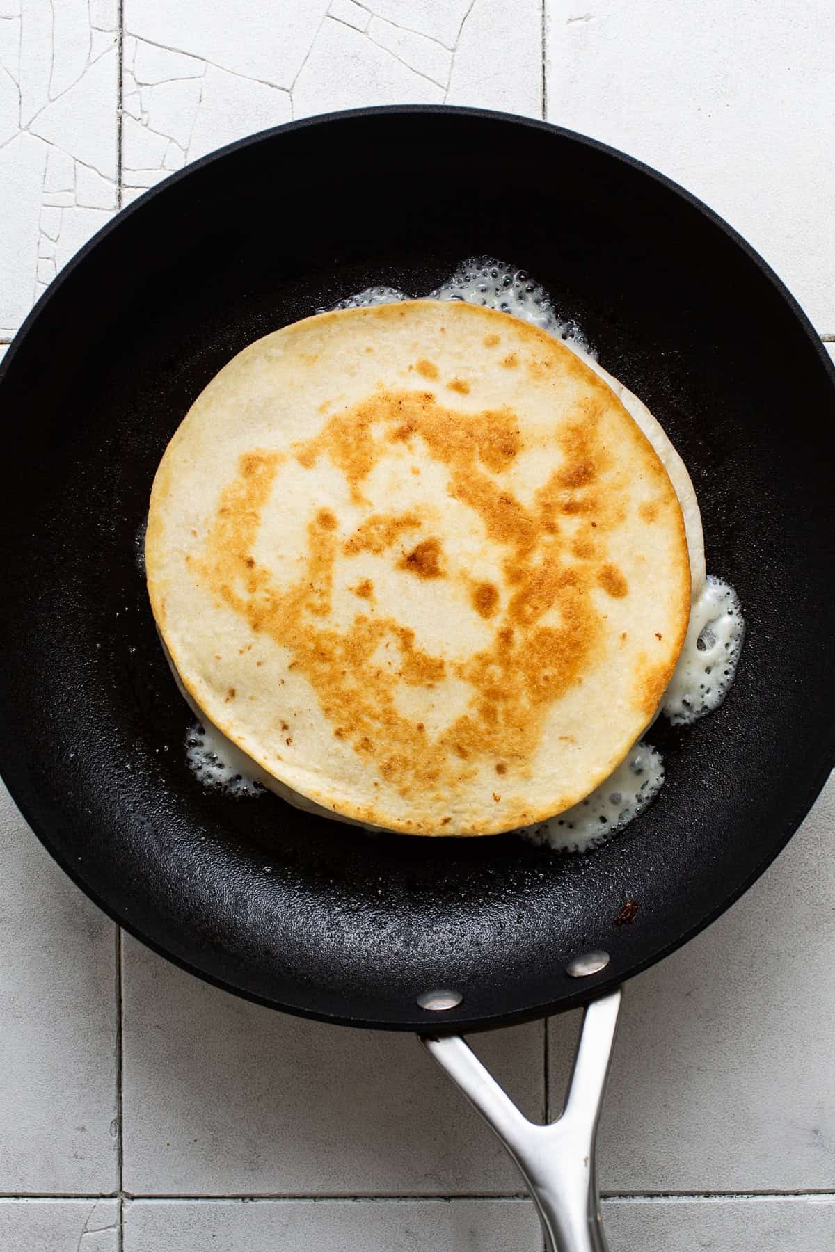 A crispy golden sincronizada in a skillet ready to be sliced and served.