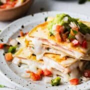 A sincronizada de jamon on a plate stacked on top of one another.