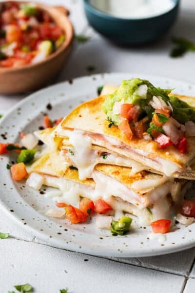 A sincronizada de jamon on a plate stacked on top of one another.