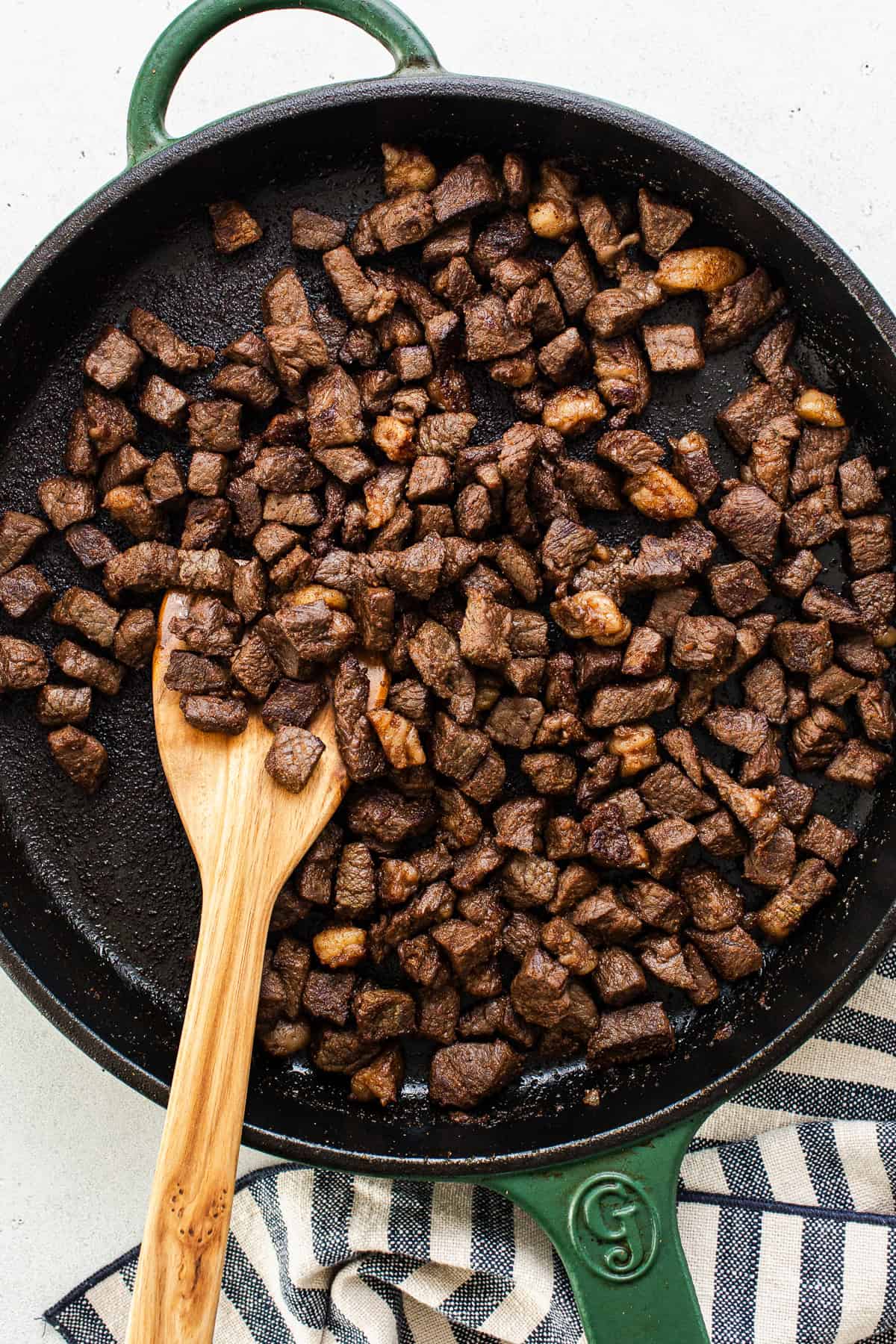 Cooked diced carne asada sirloin steak in a skillet for vampiro tacos.
