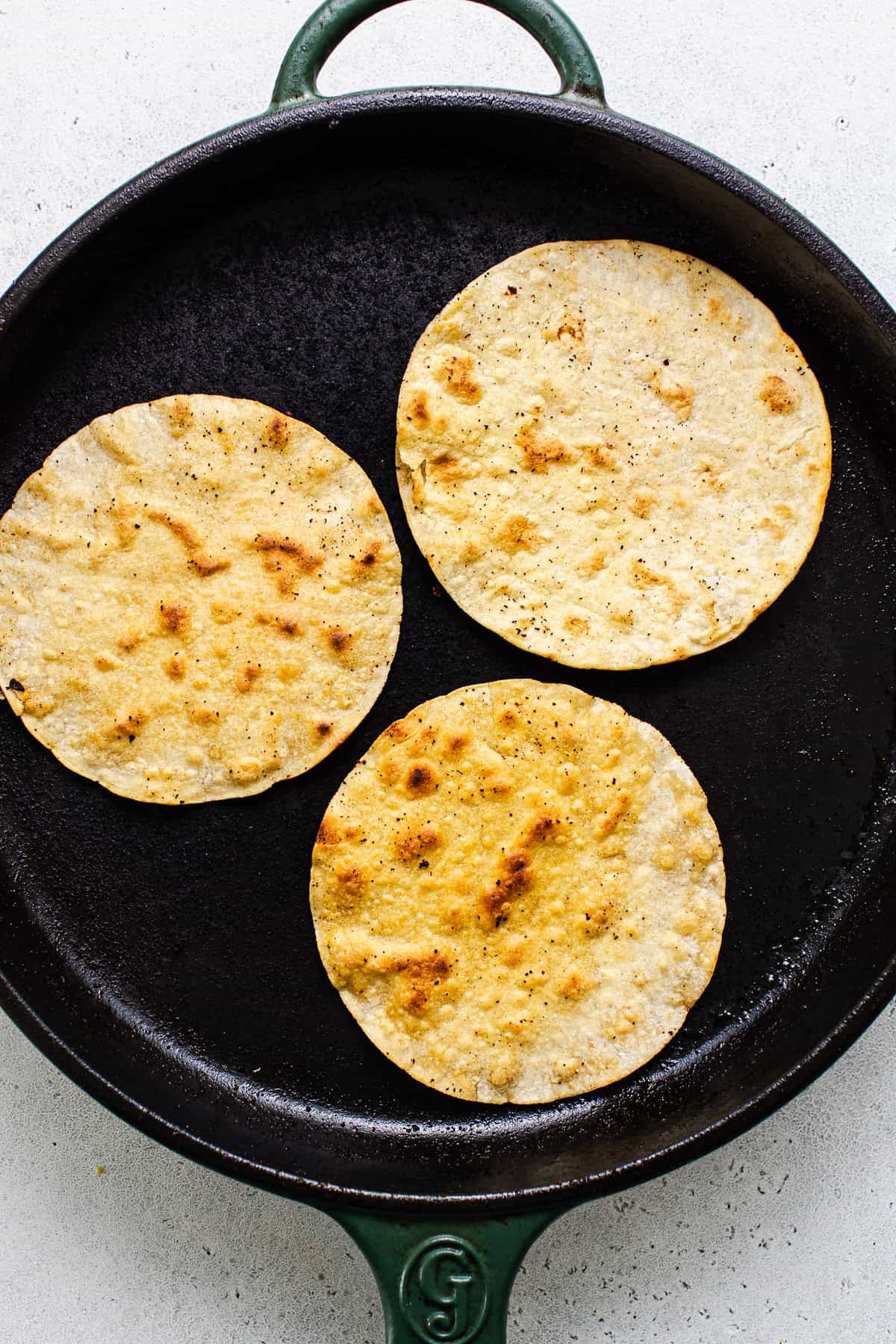Crispy corn tortillas on a dry skillet.