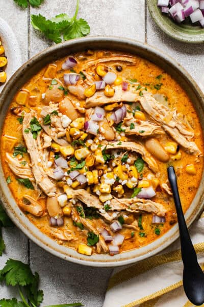 A bowl of Mexican street corn white chicken chili ready to be eaten.