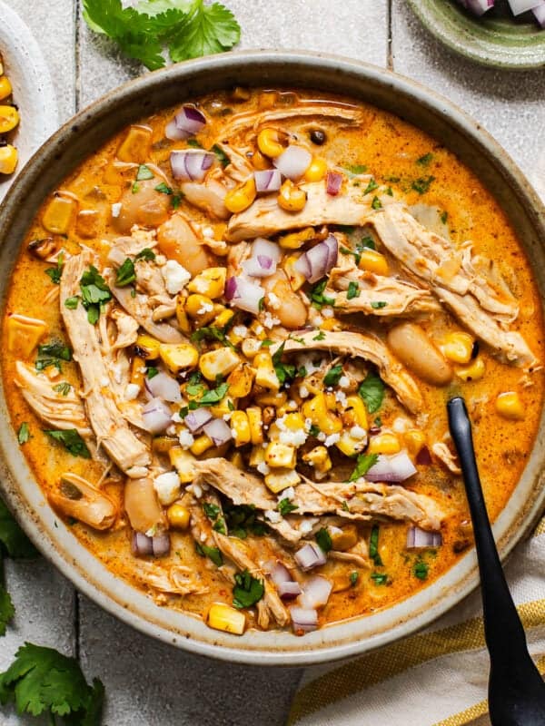 A bowl of Mexican street corn white chicken chili ready to be eaten.