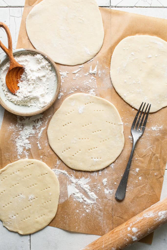 Chalupa dough rolled into a circle and pricked with a fork.