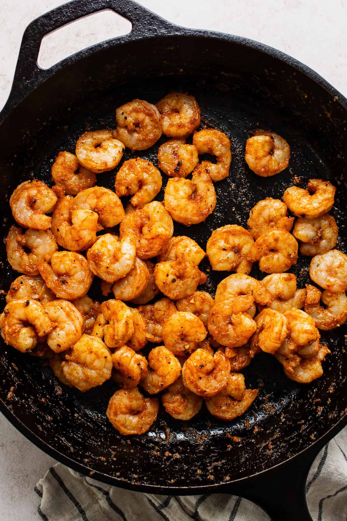 Cooked seasoned shrimp in a skillet for shrimp tostadas.