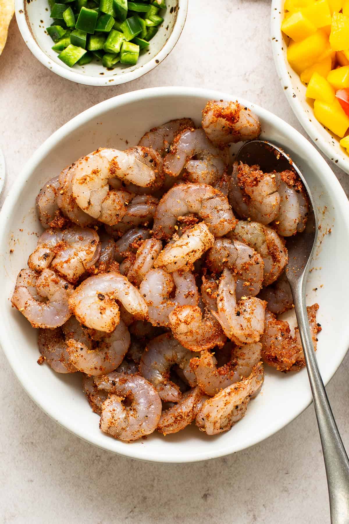 Seasoned raw shrimp in a bowl for shrimp tostadas.