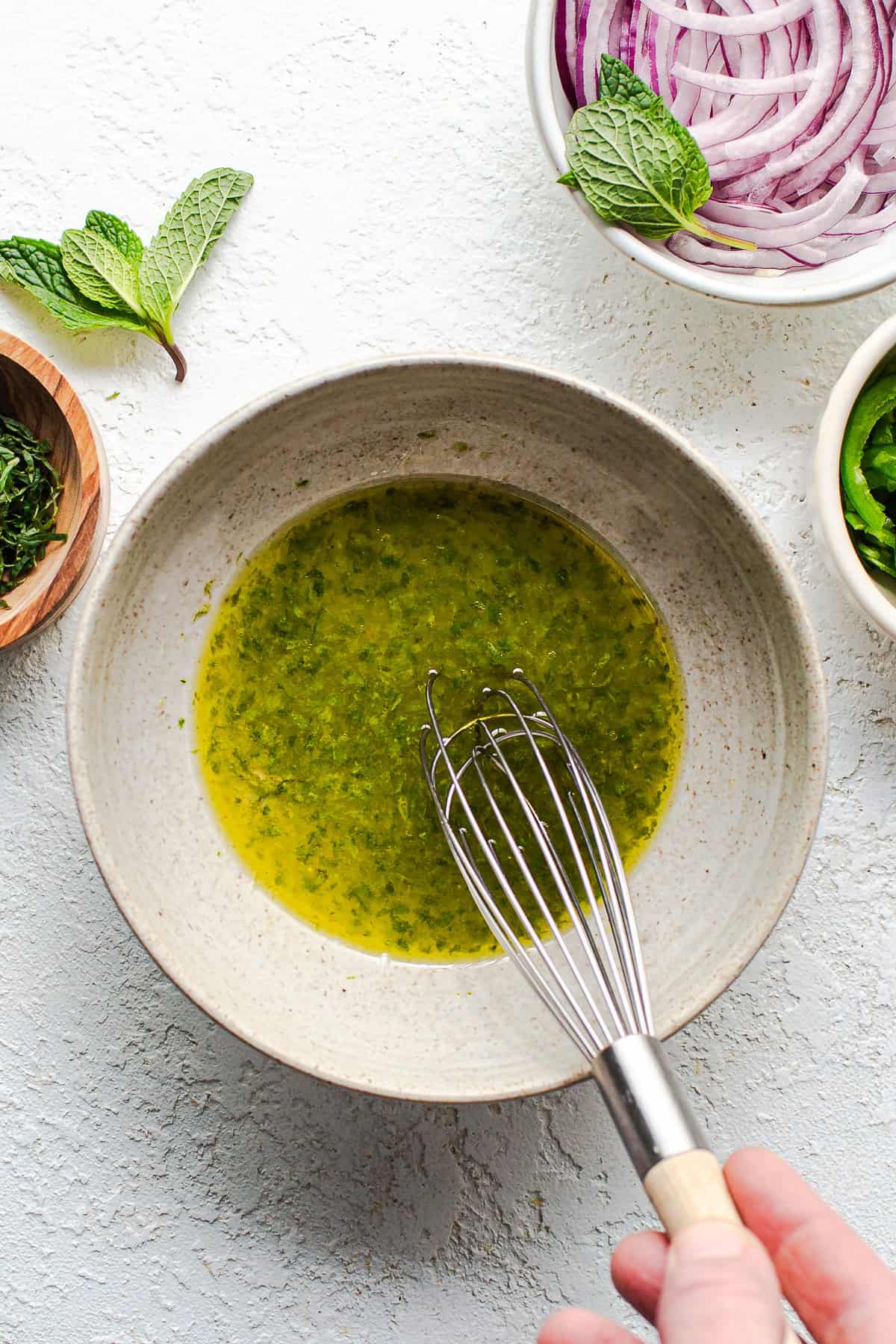 Lime dressing whisked together in a small bowl for watermelon salad.