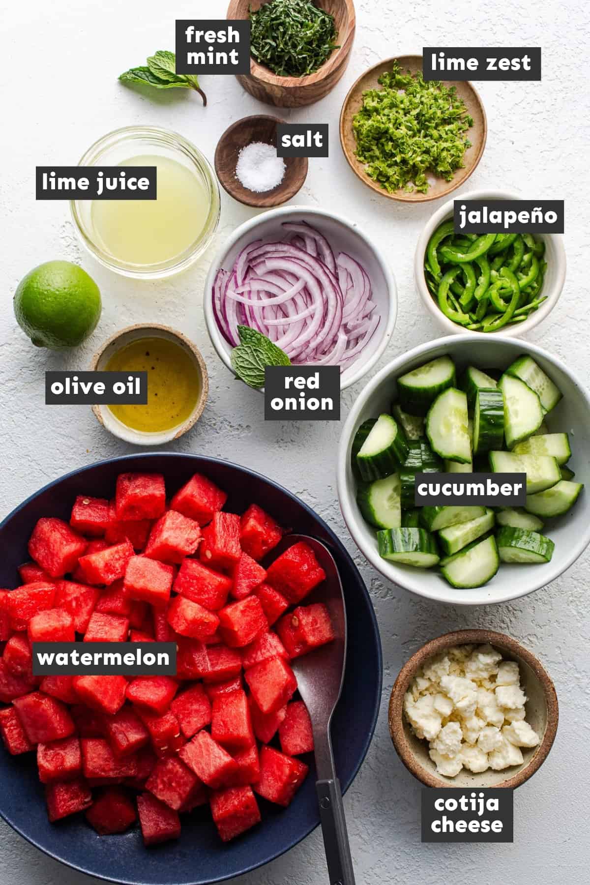 Ingredients in watermelon salad on a table.