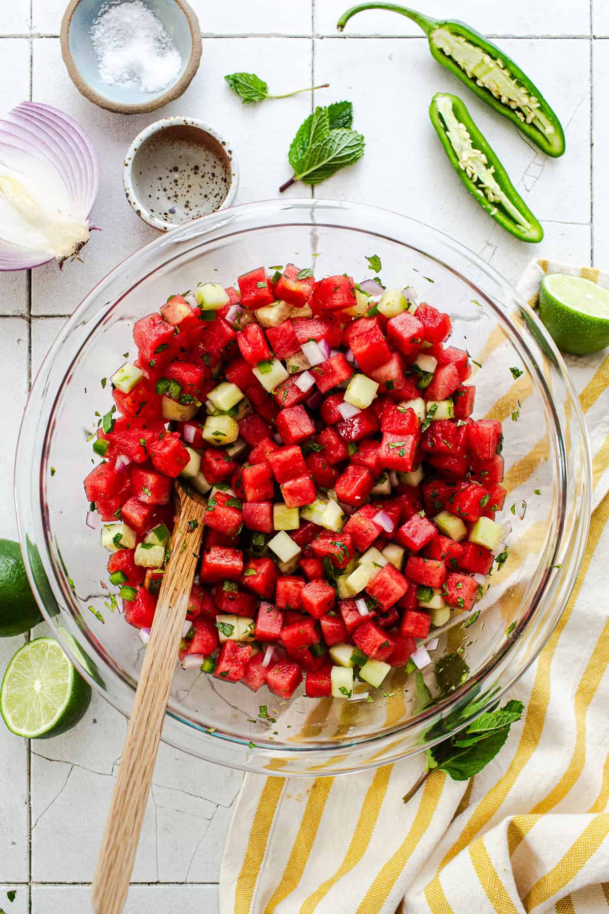 Watermelon salsa tossed together in a bowl with lime and mint.