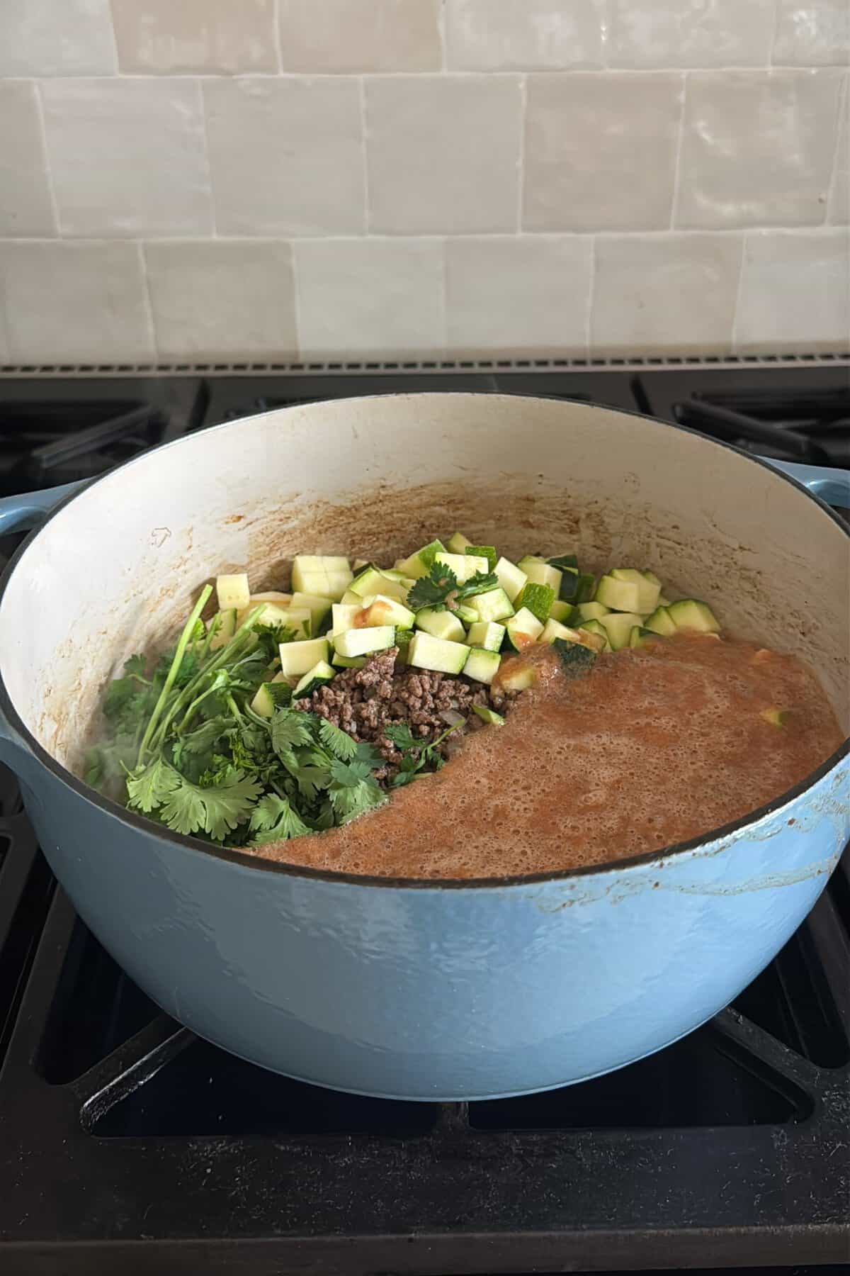 All the ingredients in a large pot for sopa de fideo con carne molida before being fully cooked.