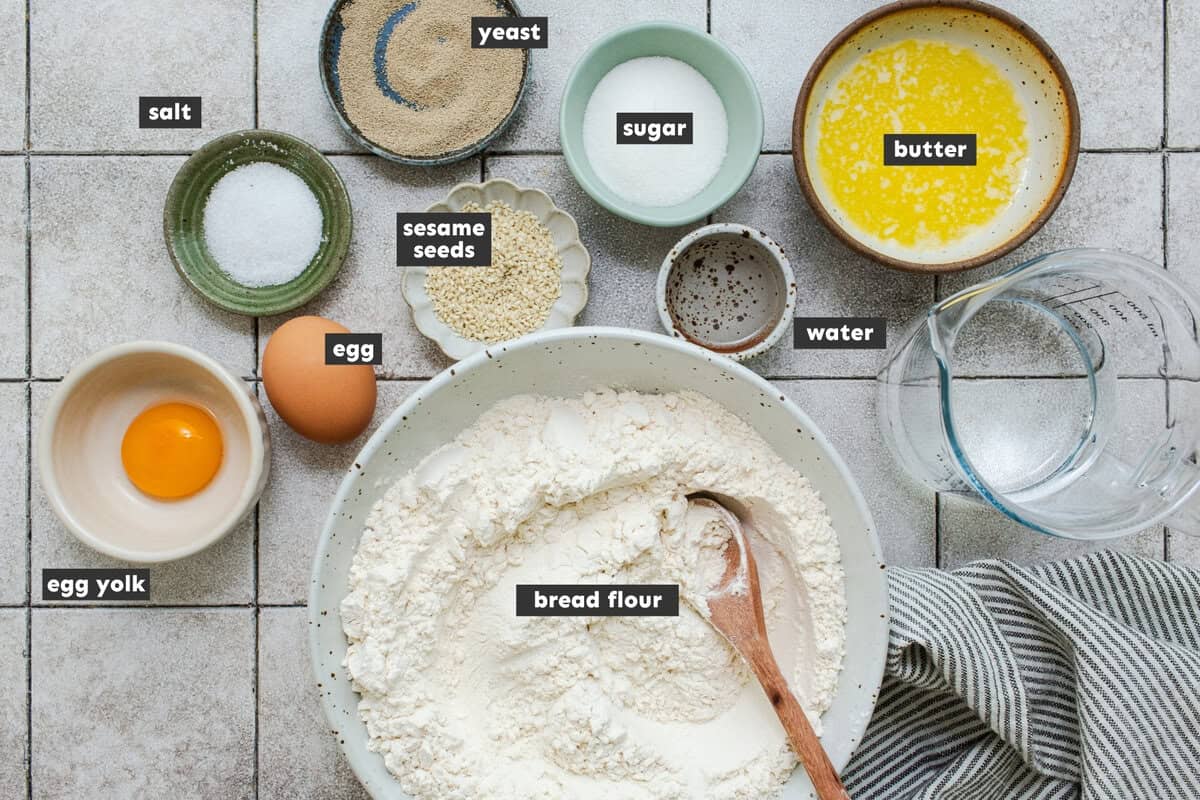 Ingredients for cemita buns: bread flour, yeast, butter, egg, sugar, salt, and sesame seeds.