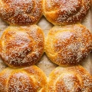 Golden baked cemita buns (mexican sesame bread) on a baking sheet