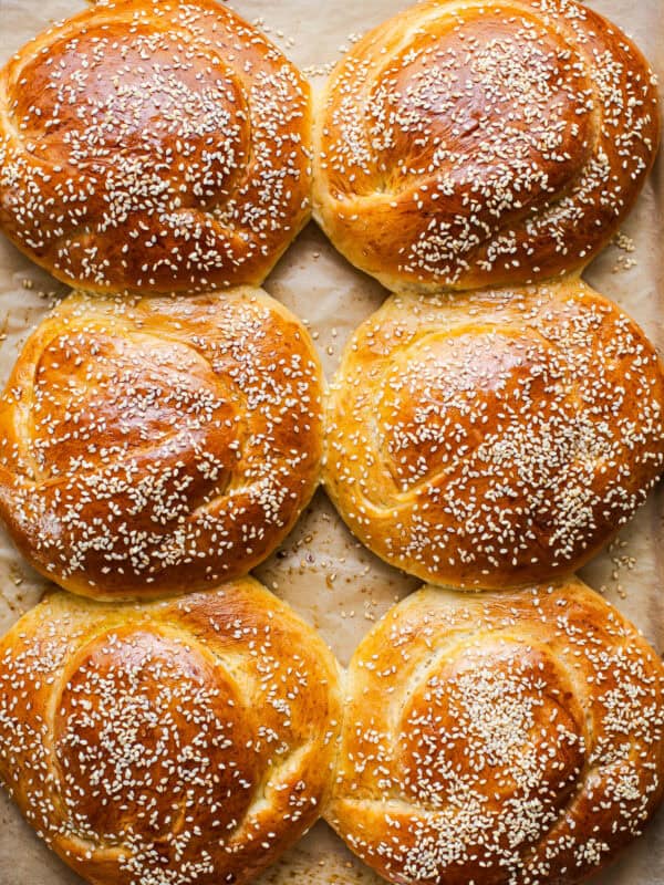 Golden baked cemita buns (mexican sesame bread) on a baking sheet