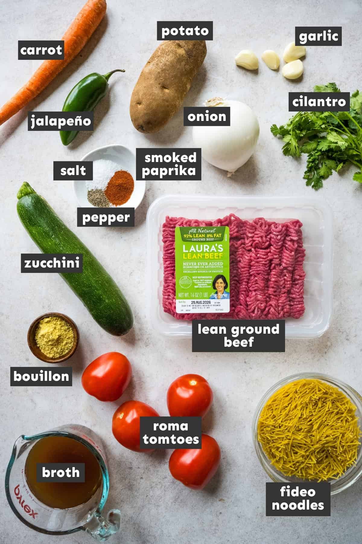 Ingredients for sopa de fideo con carne molida on a table.