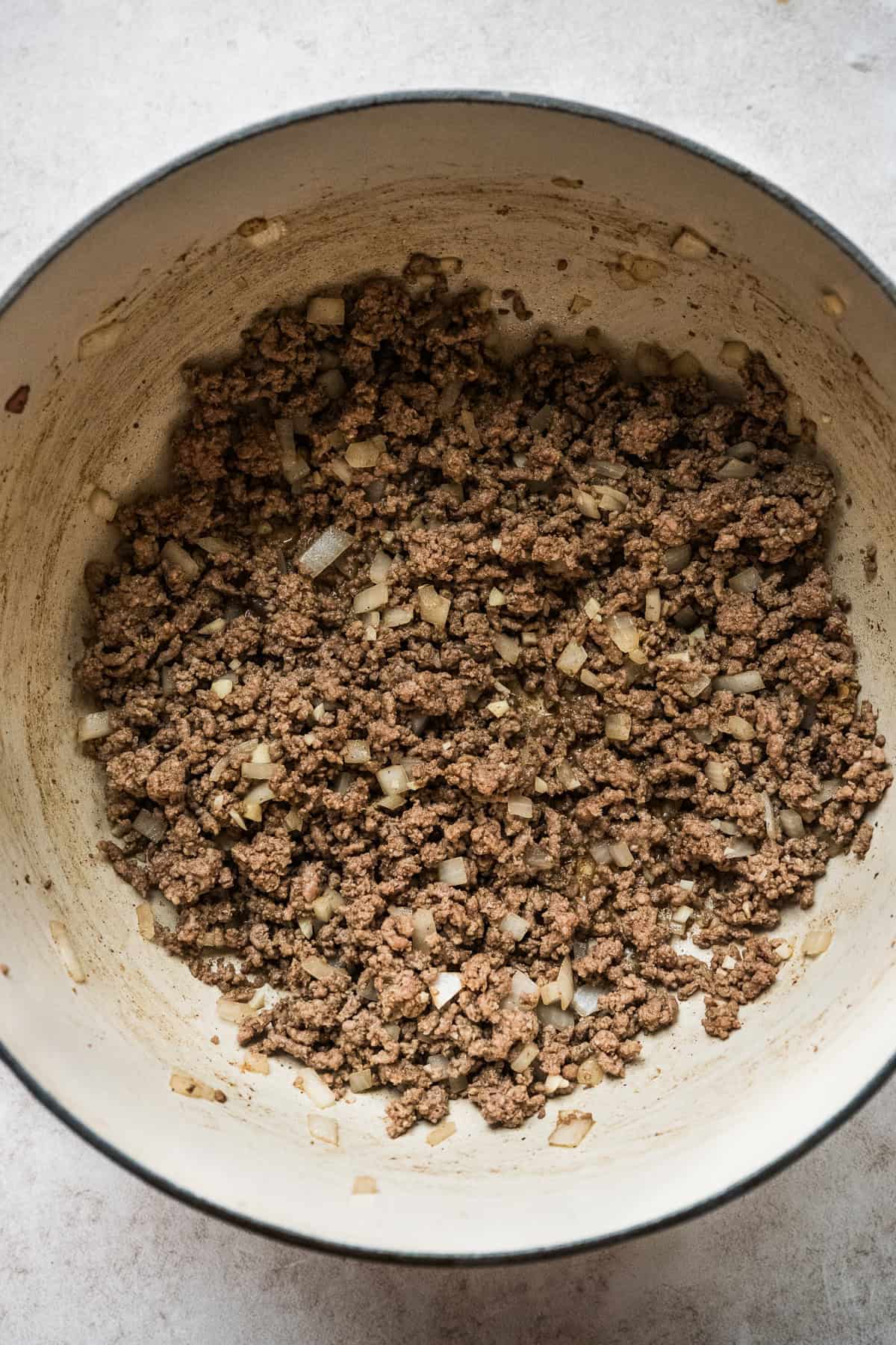 Browned beef, onions, and garlic in a large Dutch oven.