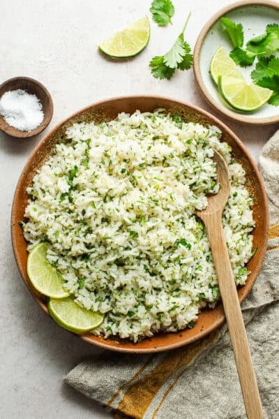 Cilantro lime rice in a serving bowl with a spoon.
