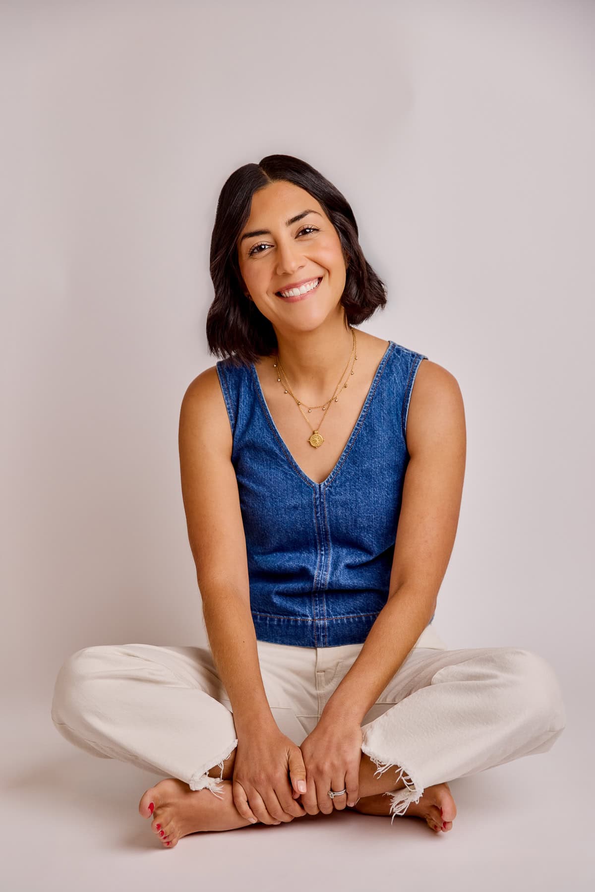 Isabel Orozco-Moore sitting and smiling at the camera.