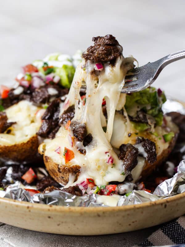 Cheese pull from a carne asada papas locas baked potato.