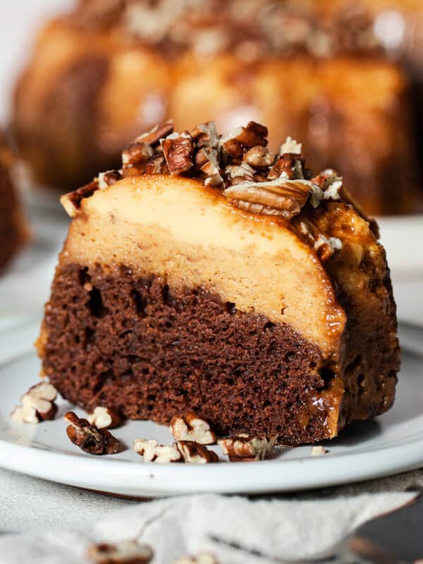 A slice of pumpkin chocoflan showing the pumpkin flan layer on top of the chocolate cake.