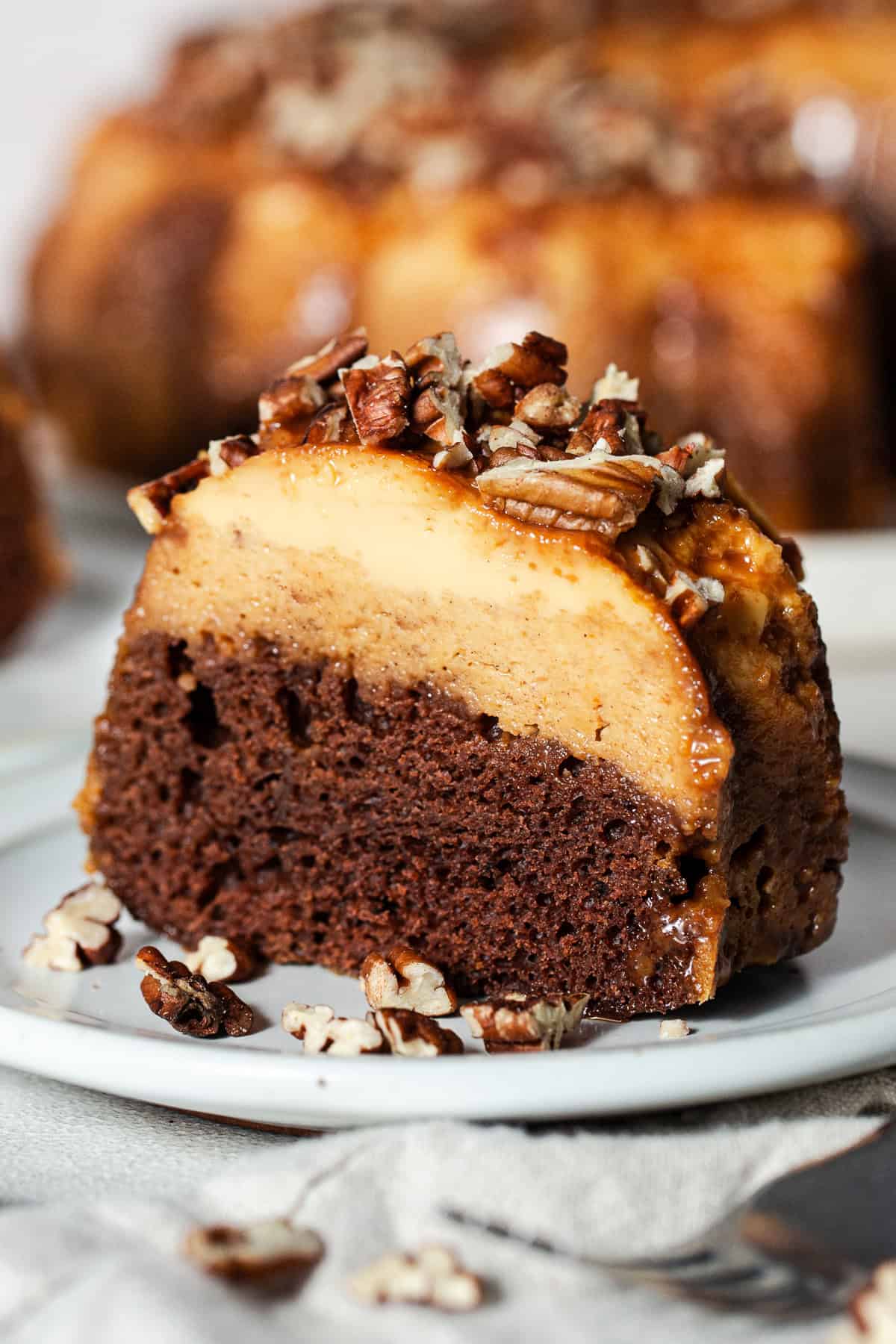 A slice of pumpkin chocoflan showing the pumpkin flan layer on top of the chocolate cake.