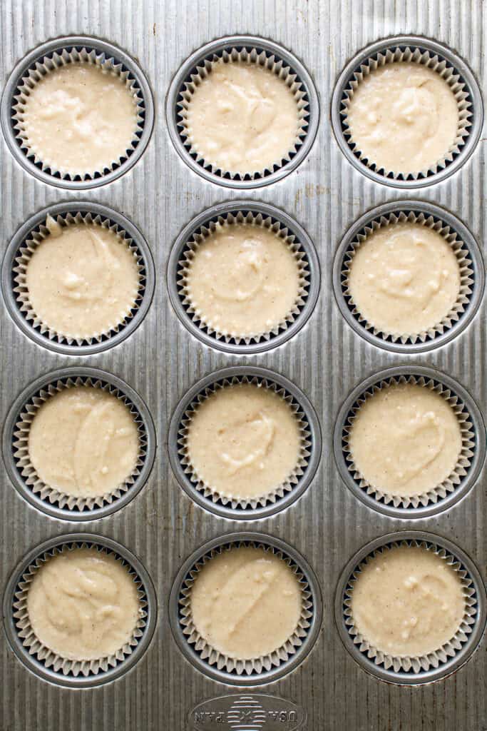 Tres leches cupcake batter in a foil-lined muffin pan before baking.